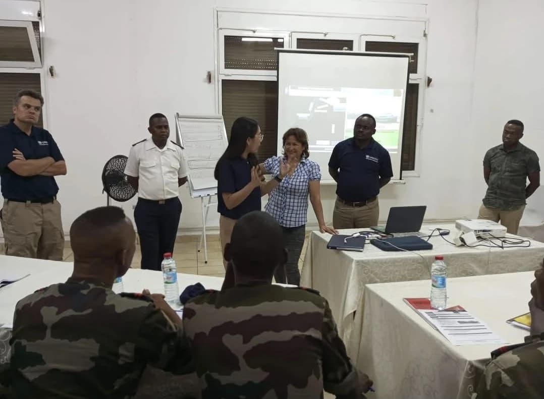 A speaker addressing a small group in a workshop room